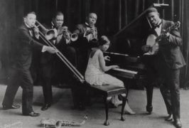 Members of Hot Five gather around Lil at piano